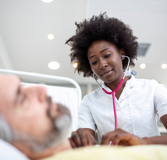 senior-patient-bed-talking-african-american-female-doctor-hospital-room-health-care-insurance-concept-doctor-comforting-elderly-patient-hospital-bed-counsel-diagnosis-health 1