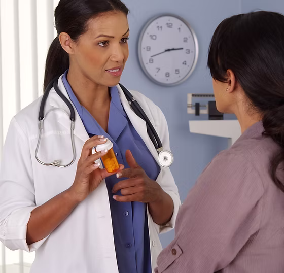 African American physician talking to hispanic patient about medicine